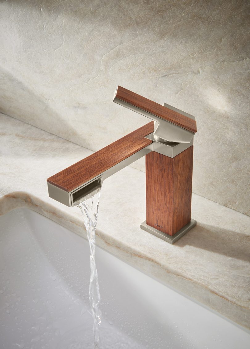 wood and metal angular sink faucet with water turned on