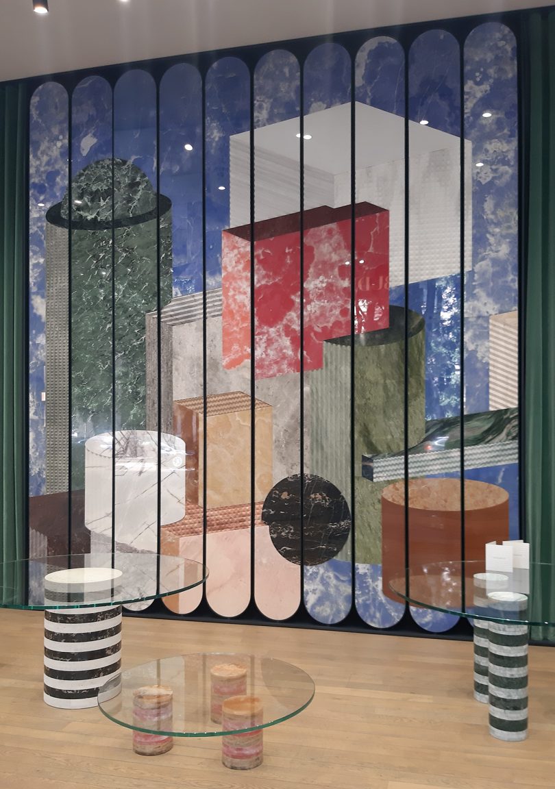 striped objects in front of a large wall mural