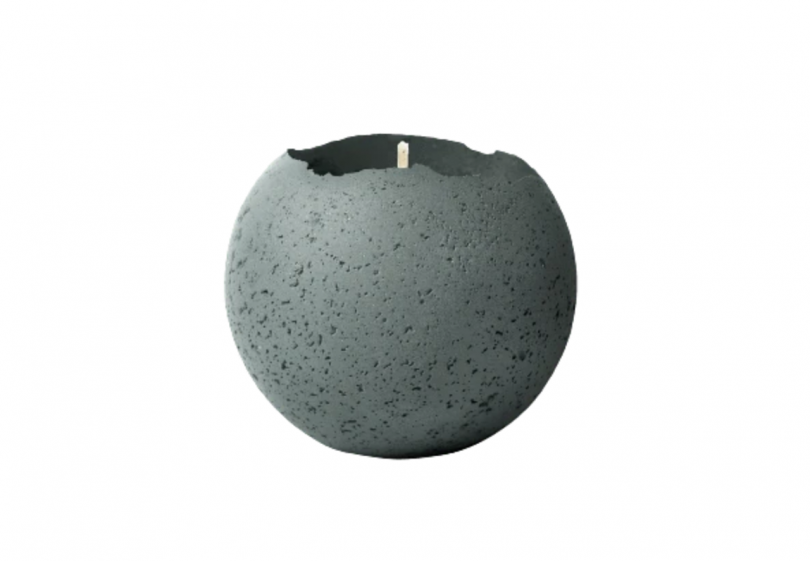 round concrete vessel holding a candle