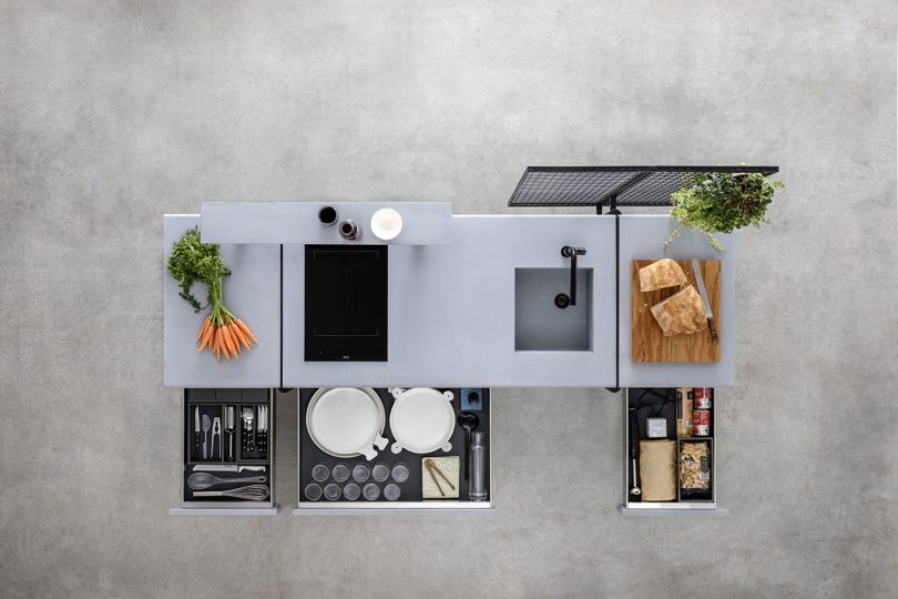 overhead shot of open space styled kitchen on concrete floor