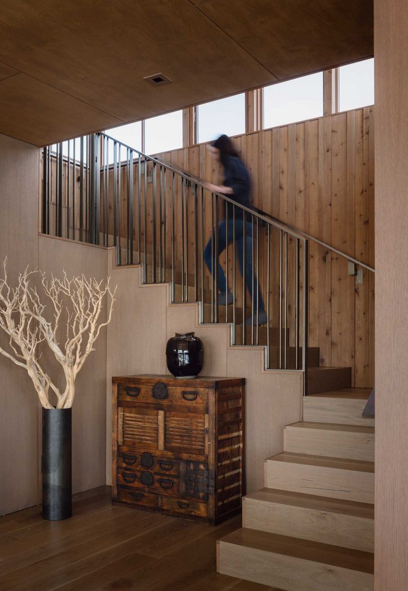 modern staircase with person walking up to second floor