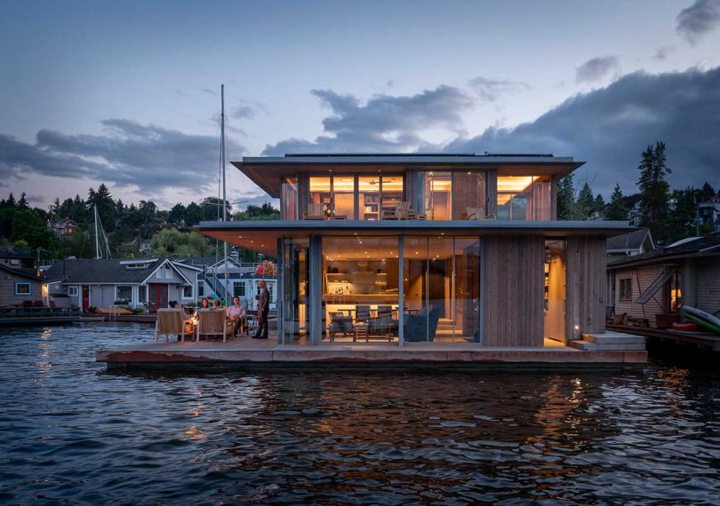 modern floating house on water in the evening