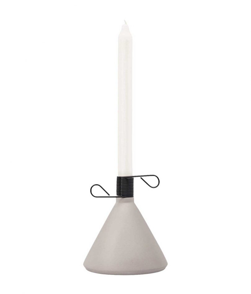 industrial-inspired cone-shaped candle holder with black spring and white candle