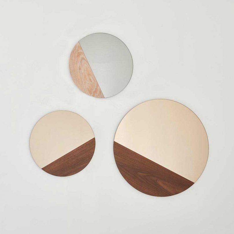 three round mirrors with sections of wood 