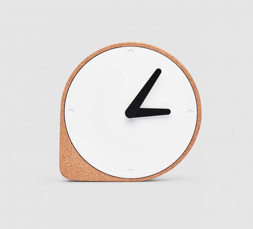 modern cork clock with white metal face and black hands