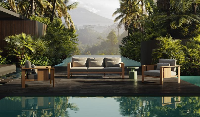 outdoor furniture sitting in front of a pool surrounded by nature