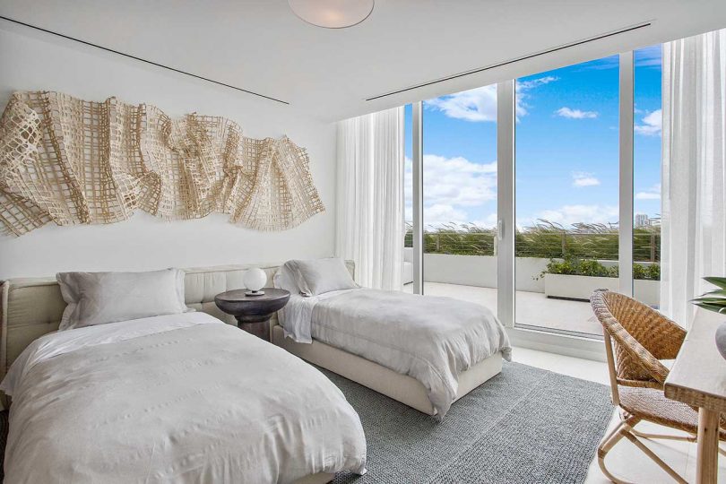 modern bedroom with twin beds in light, natural tones