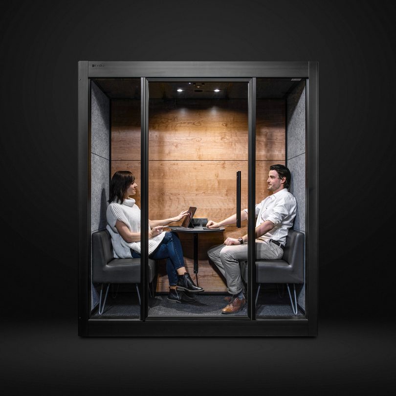 workspace pod with two people inside on dark background