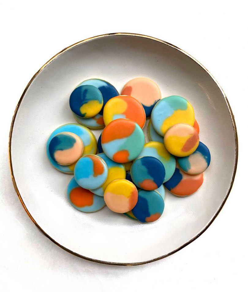 plate of cookies with swirled colorful icing