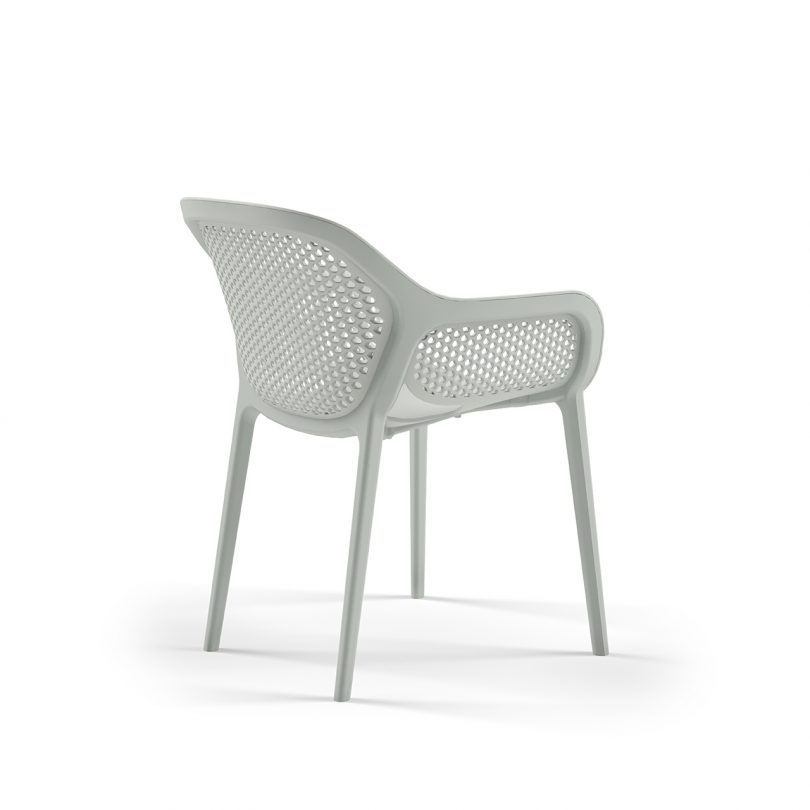 three quarter photo of light colored outdoor armchair on white background
