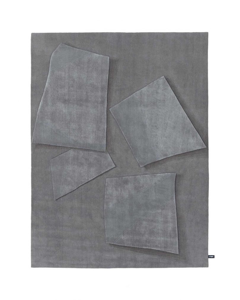 grey floor rug with geometric shapes on white background