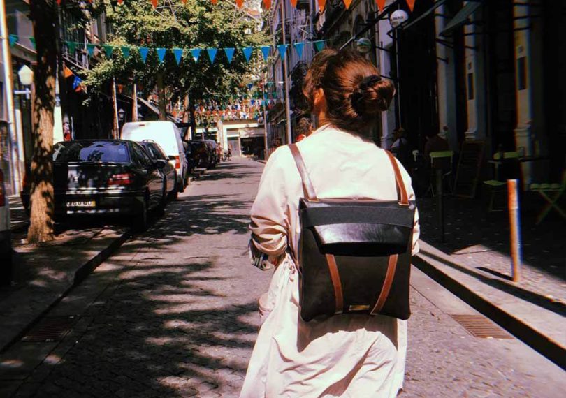 woman wearing the mariamaleta everyday backback walking down the street