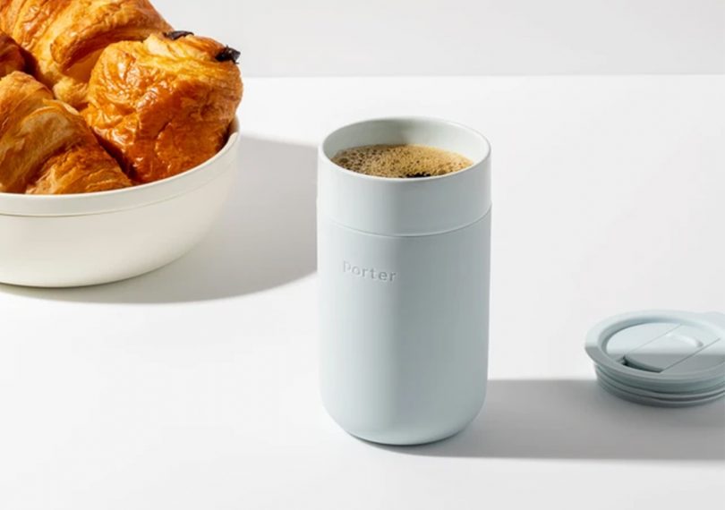 Porter 16 oz ceramic mug with coffee inside on a marble tabletop