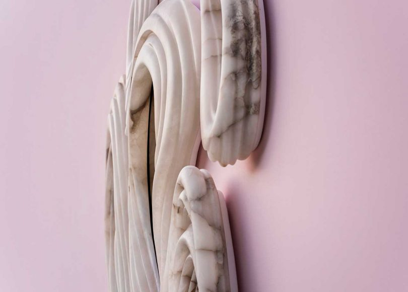abstract wall mirrors hanging on pink wall