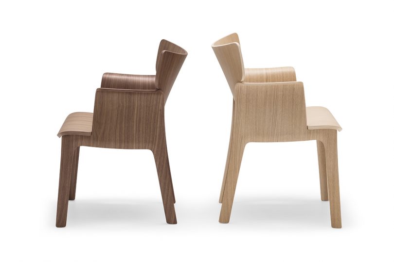 two wood armchairs back to back on white background