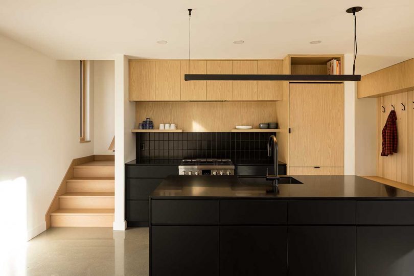 compact modern kitchen in black and wood tones