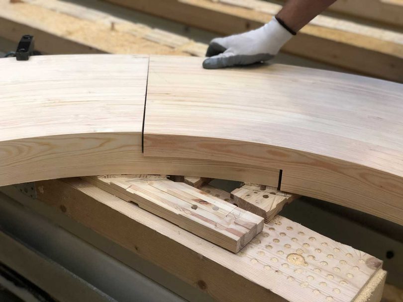 curved wooden components joining together during construction