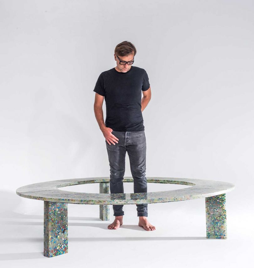 finished design of recycled plastic circular bench with designer in center