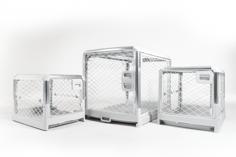 three different size dog crates on white background