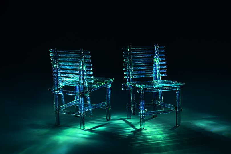 acrylic turquoise outdoor chairs in dark space with dramatic lighting