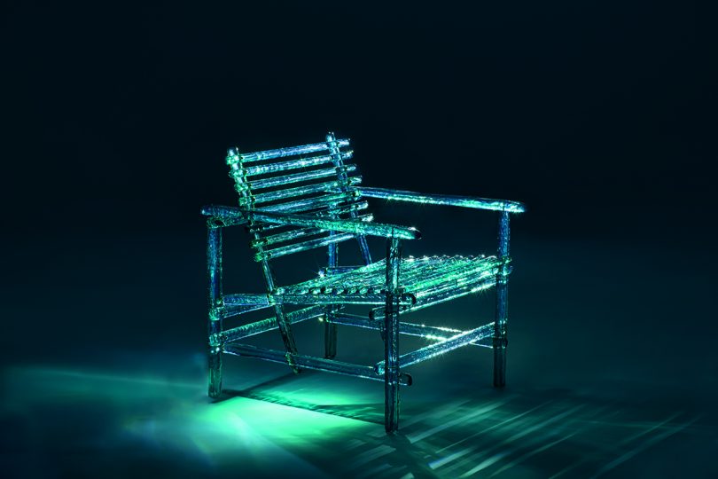 acrylic turquoise outdoor chair in dark space with dramatic lighting