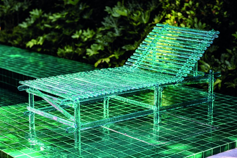 acrylic turquoise outdoor chaise longe outdoors with dramatic lighting