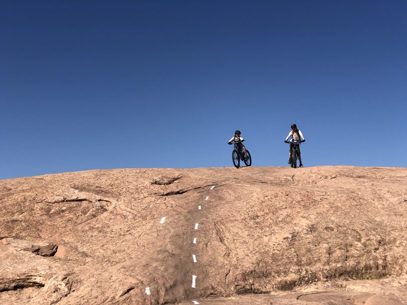 two people at the top of a mountain bike trial