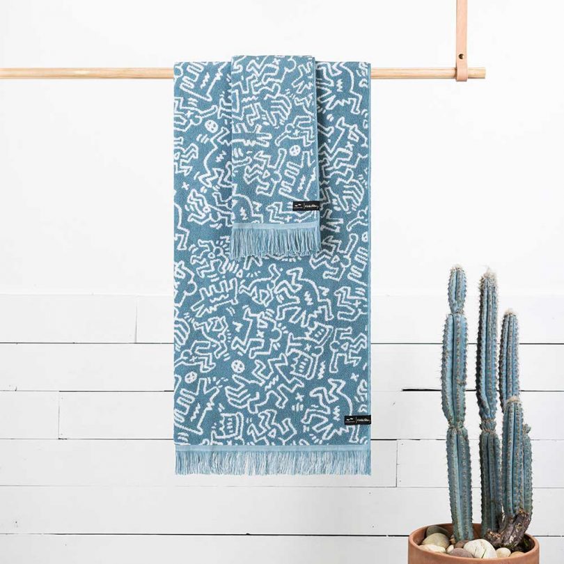 blue and white towels with Keith Haring artwork hanging