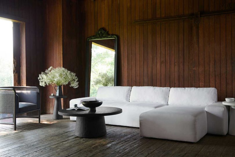 dark wood paneled living space with white sofa