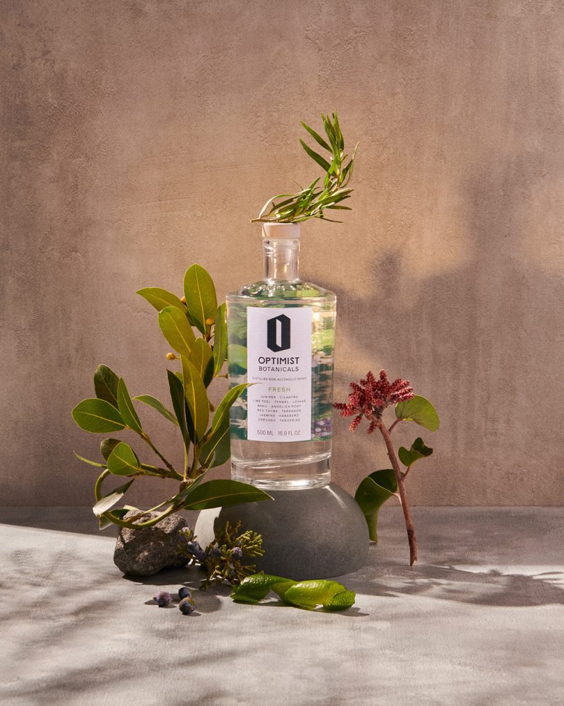 Optimist bottle styled with greenery bottle styled with greenery