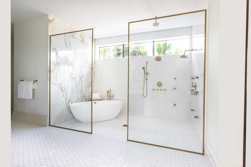 modern white bathroom with marble and brass accents