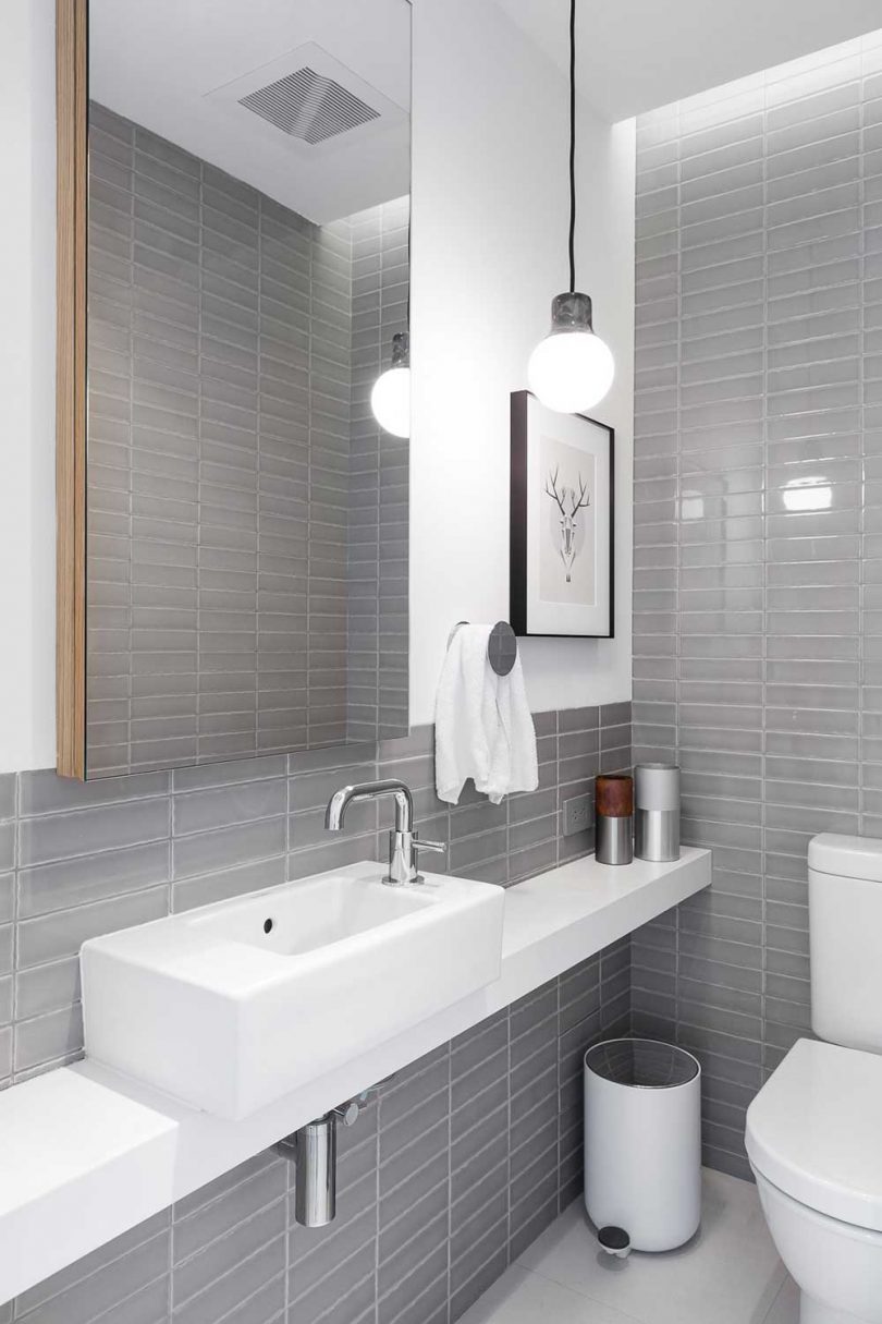 simple bathroom with gray tile and white fixtures