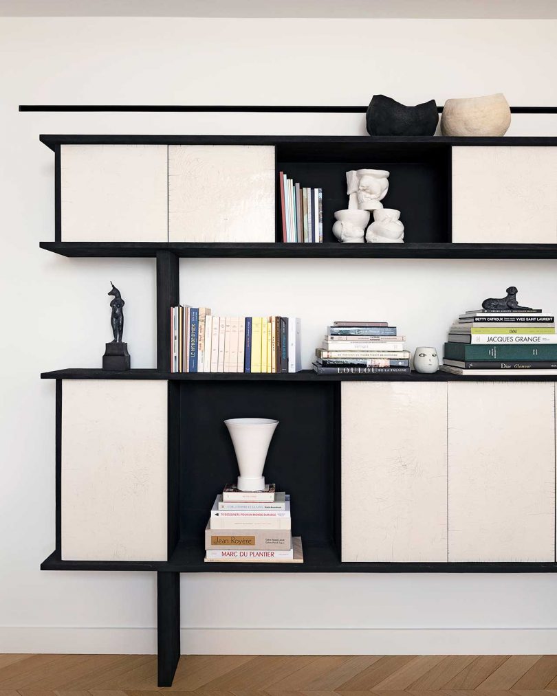 modern shelf credenza in black and cream with books and objects