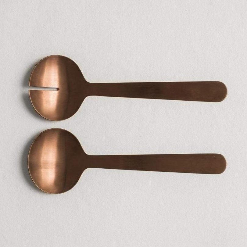 Aaron Probyn Zofia Salad Servers in Rose Gold PVD on a light grey background