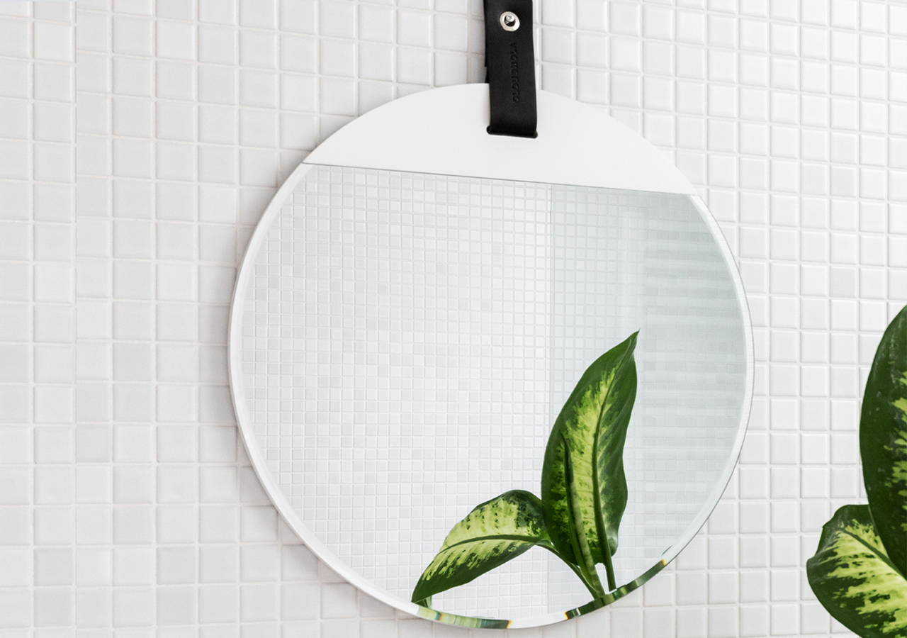 Reflect mirror in white by cloudnola hung on a white tiled wall