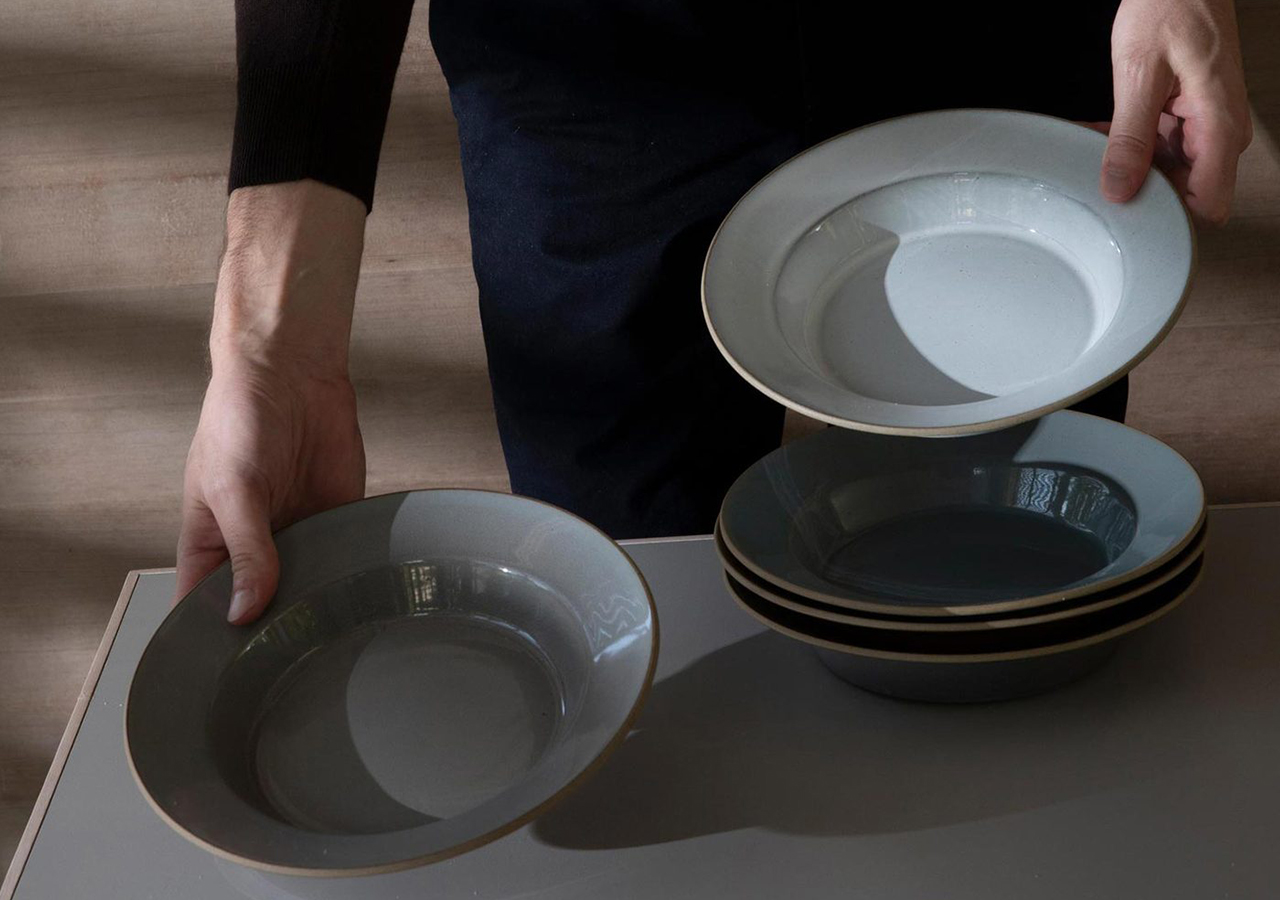 person setting a table with departo low ceramic bowls in chalk white