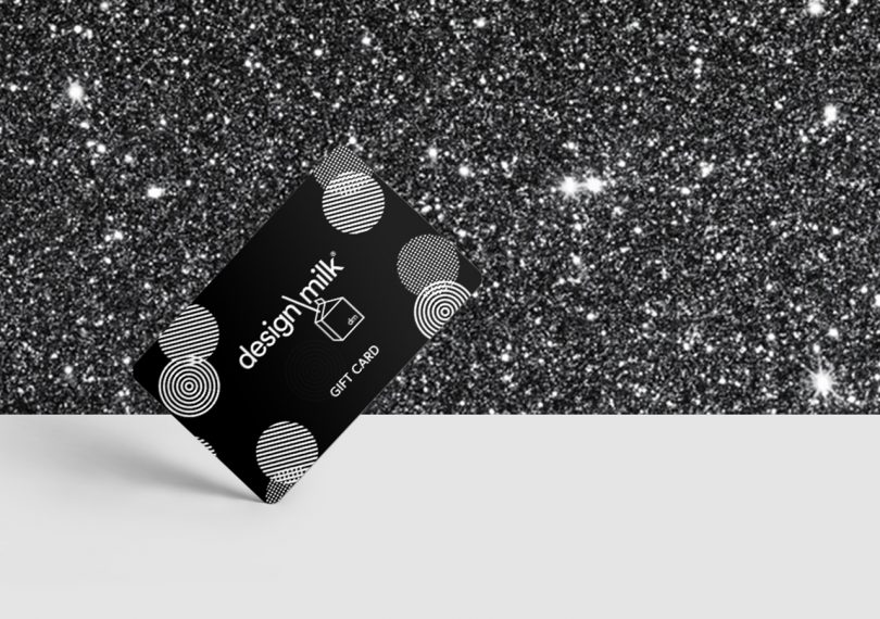 design milk gift card on a white surface with glittery background