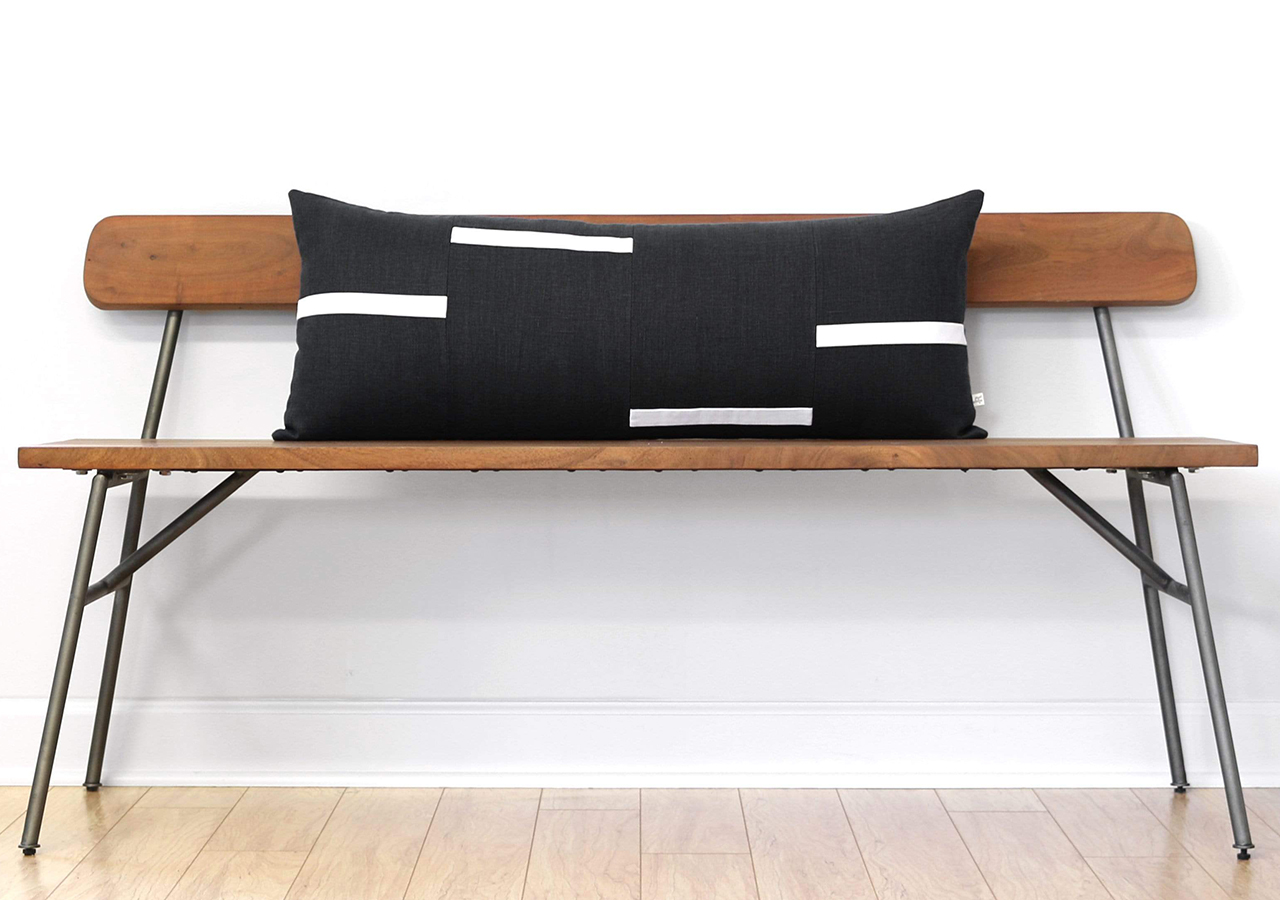 Interconnection pillow by jillian rene decor on a wooden bench