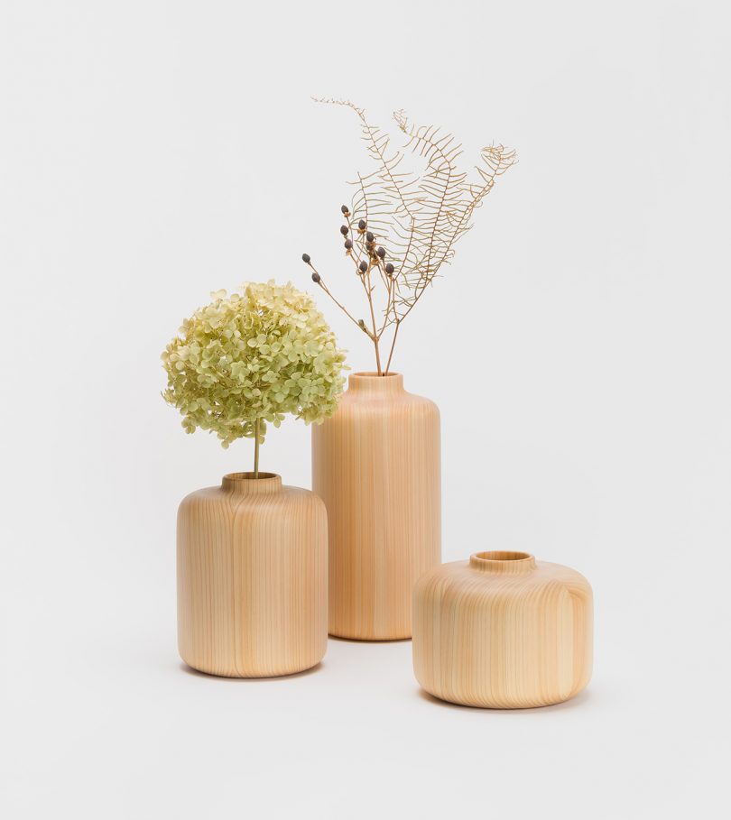 three wood vases of varying heights on white background