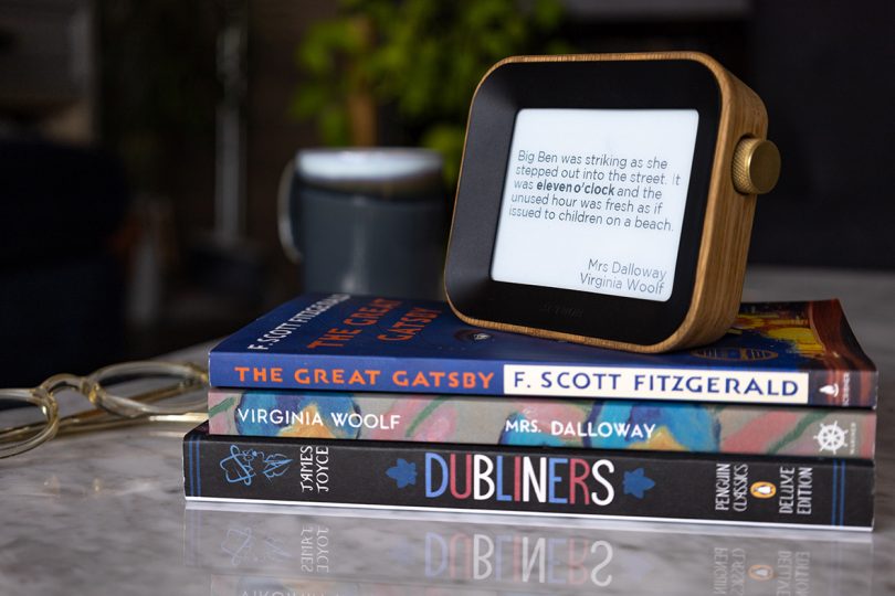 digital screen device sitting on stack of books