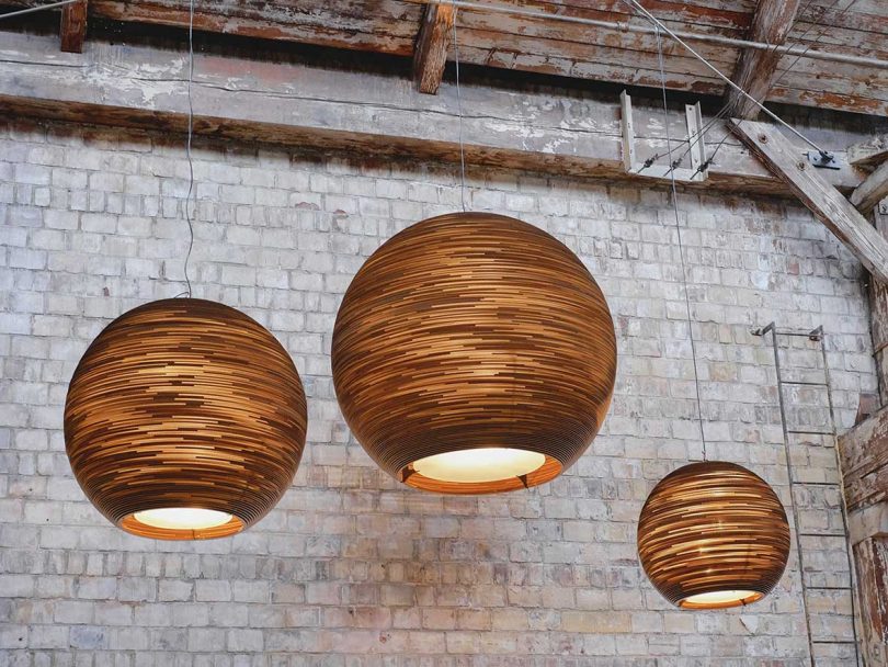 three brown cardboard globe pendant lamps hanging