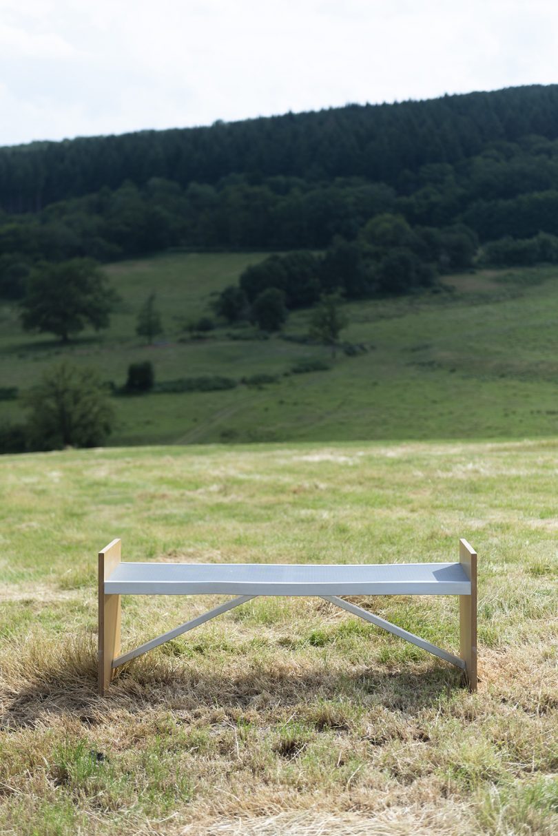 metal and wood bench outdoors on grass