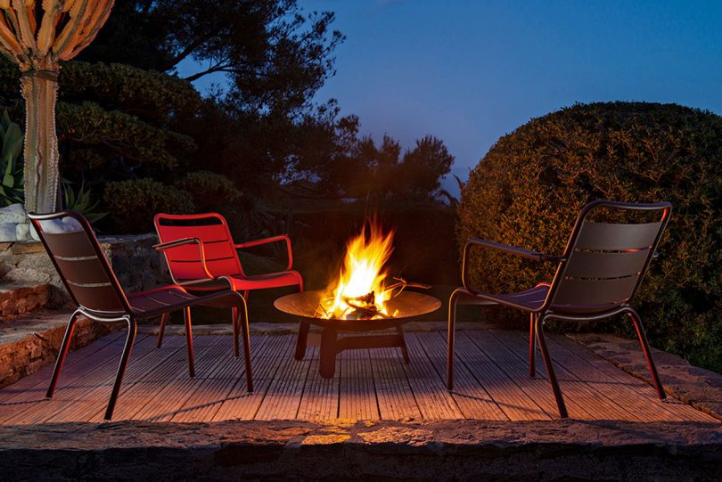 armchairs near fire pit at night