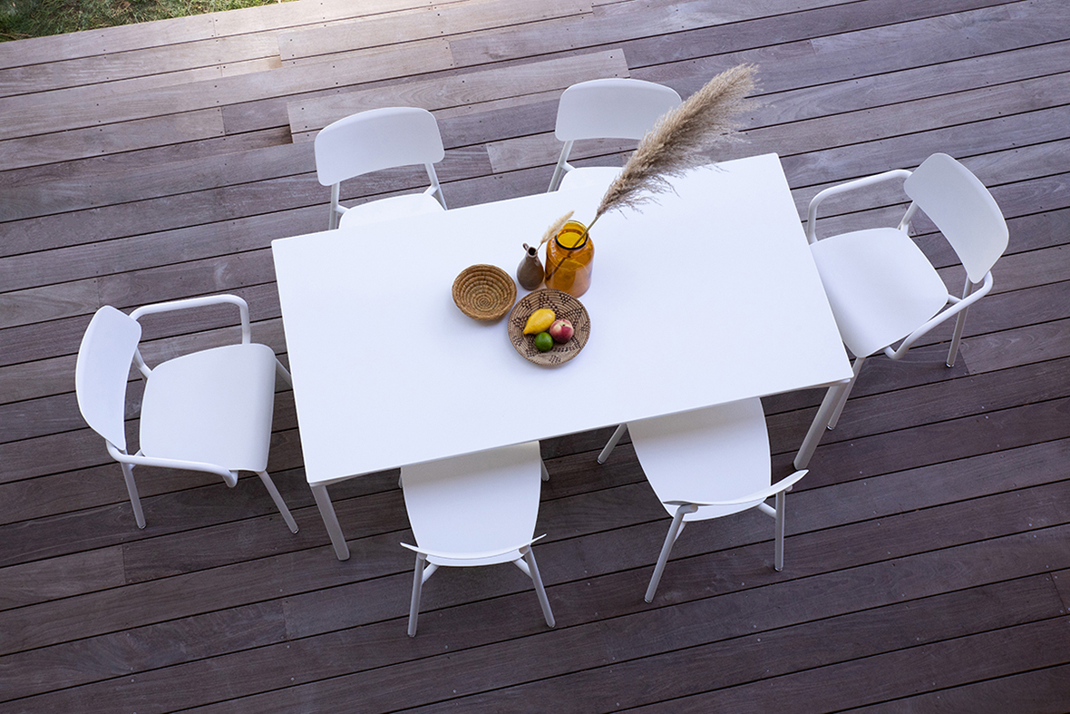 overhead photo of white outdoor table and dining chairs