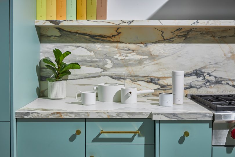 a library of pastel tea boxes with a collection of white tea accessories on marble