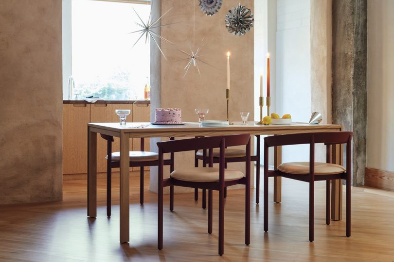 wood dining table and chairs in styled interior space