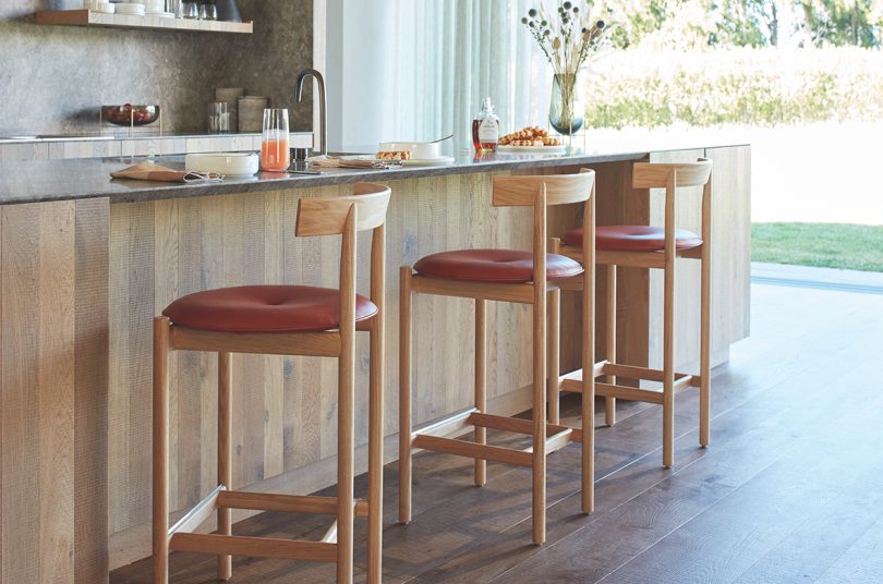 three wood stools with cushions at kitchen bar