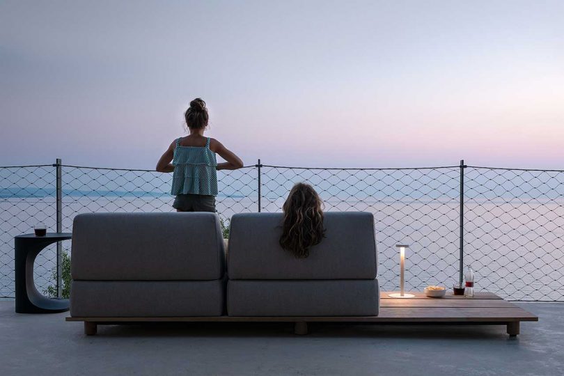 outdoor sofa overlooking ocean at dusk