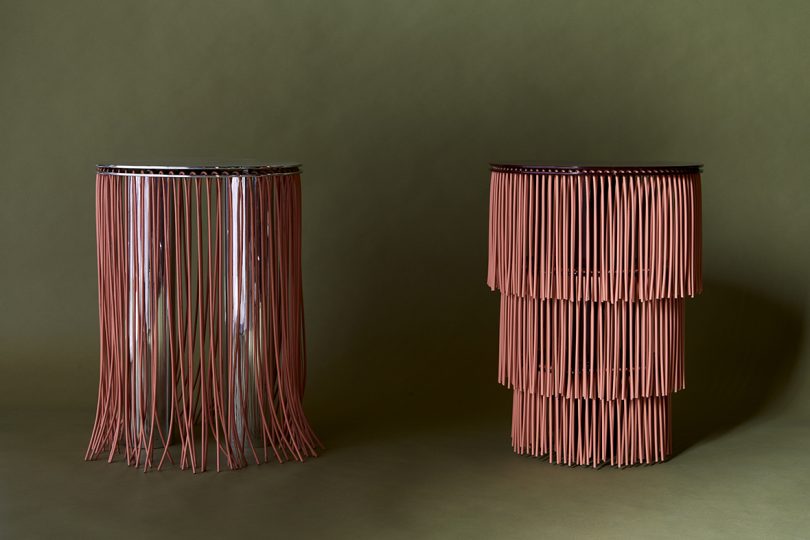 two fringed side tables on olive green background