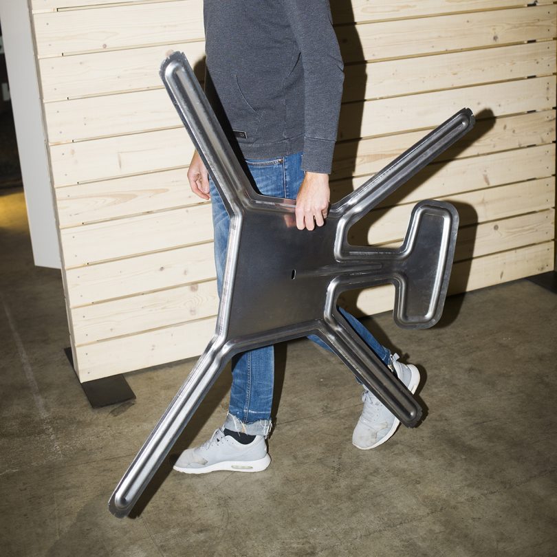man carrying aluminum chair before formation